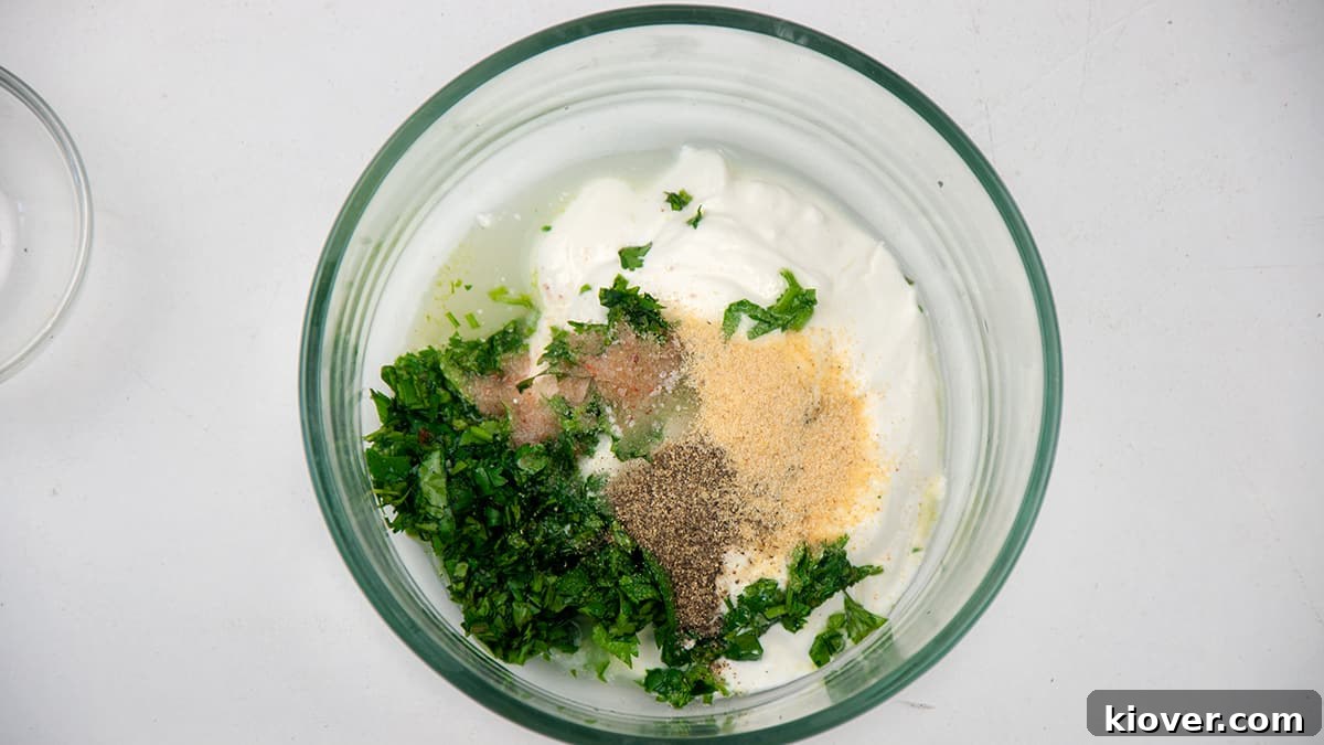Cilantro Lime Sauce Ingredients A bowl filled with cilantro lime dip ingredients that have not been mixed, showing the fresh components.