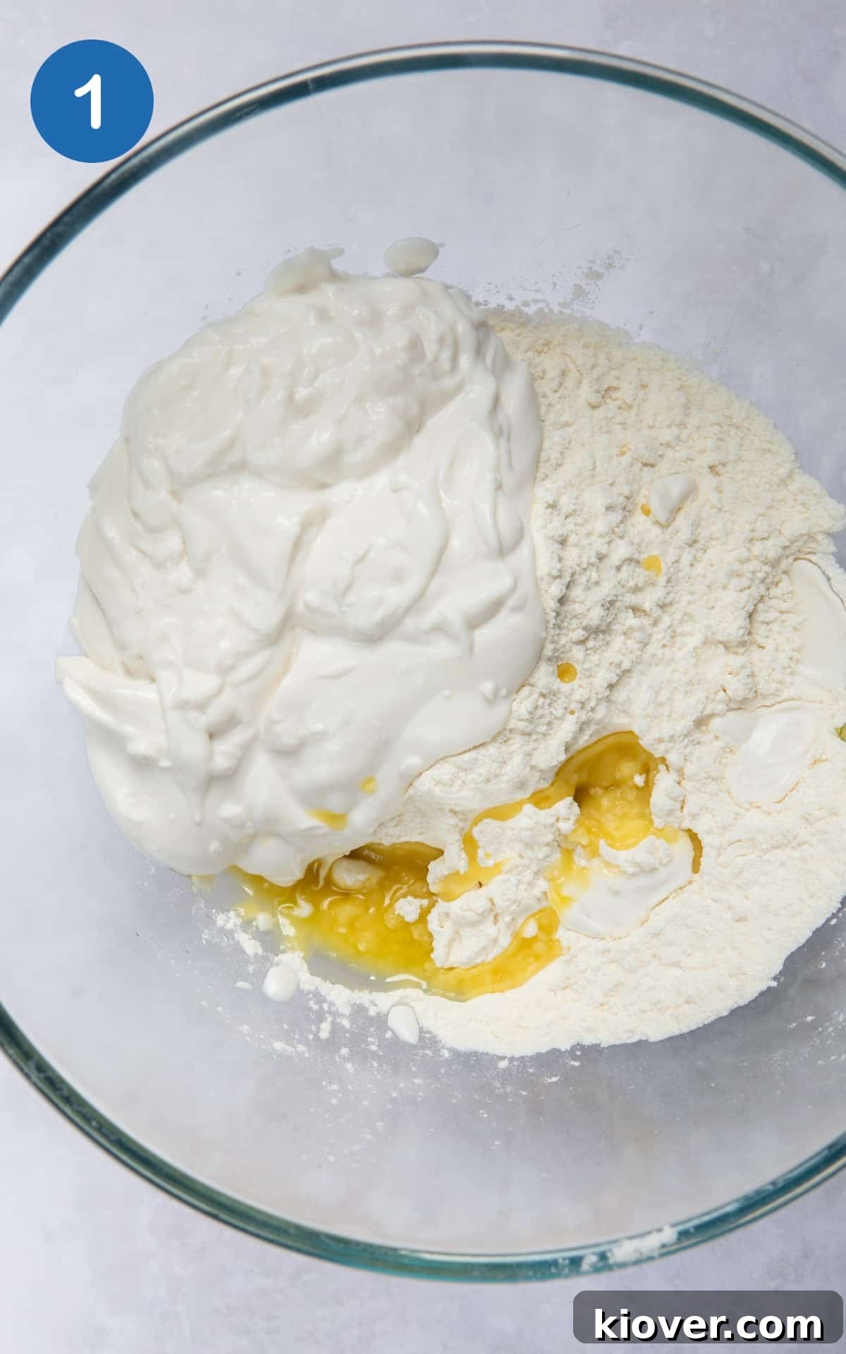 Gluten-free flour, yogurt, olive oil, and sea salt gathered in a large mixing bowl, ready to be combined.