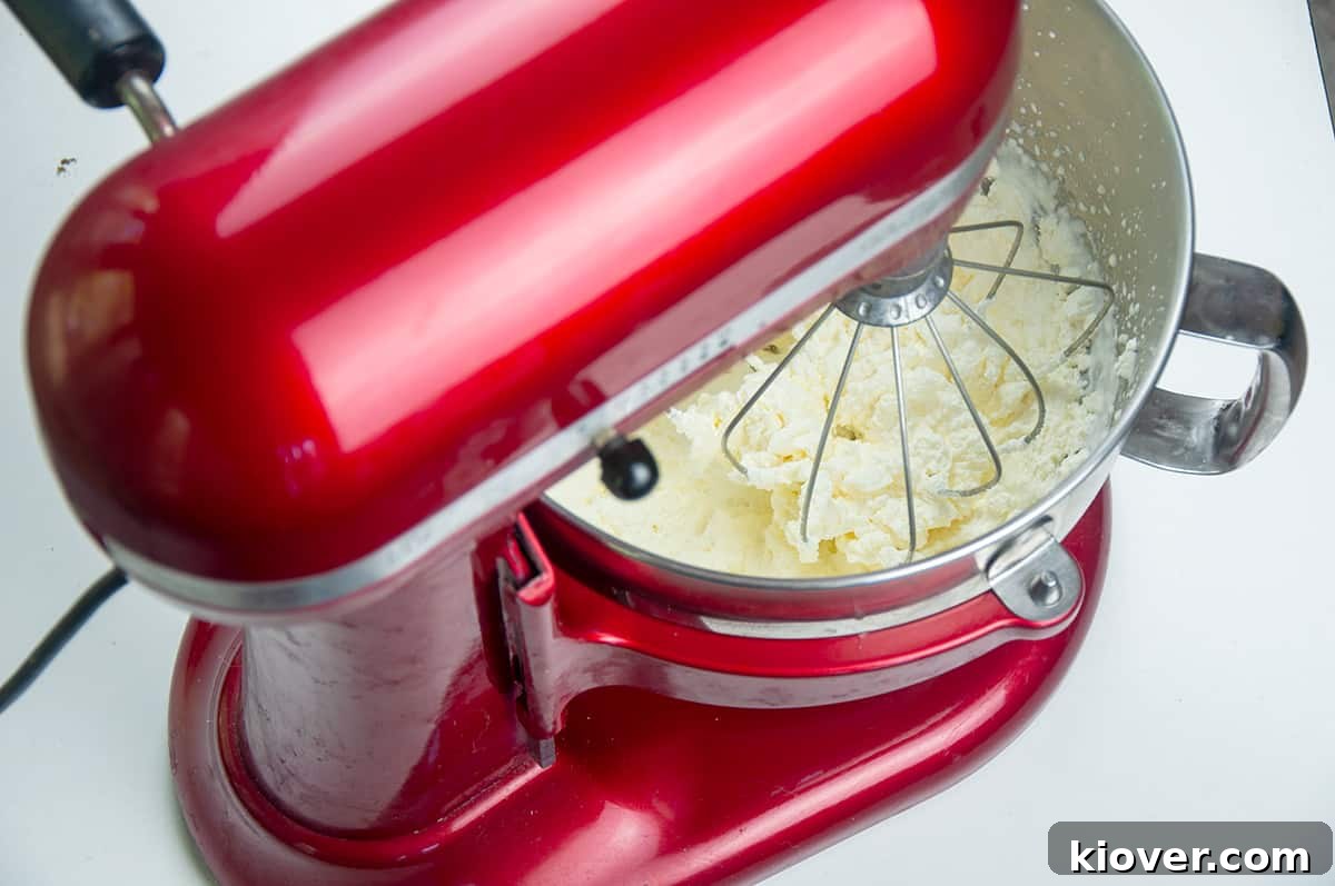 Whipped heavy cream in a KitchenAid stand mixer.