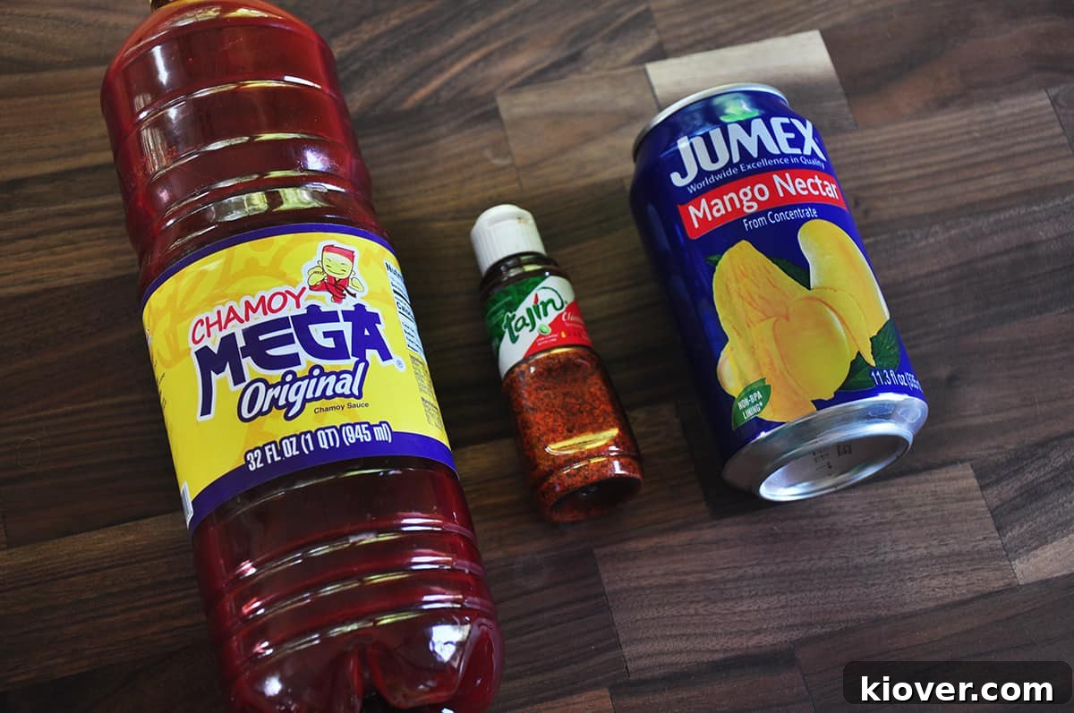 Chamoy, Tajin, and Mango Nectar laid out on a wood cutting board.