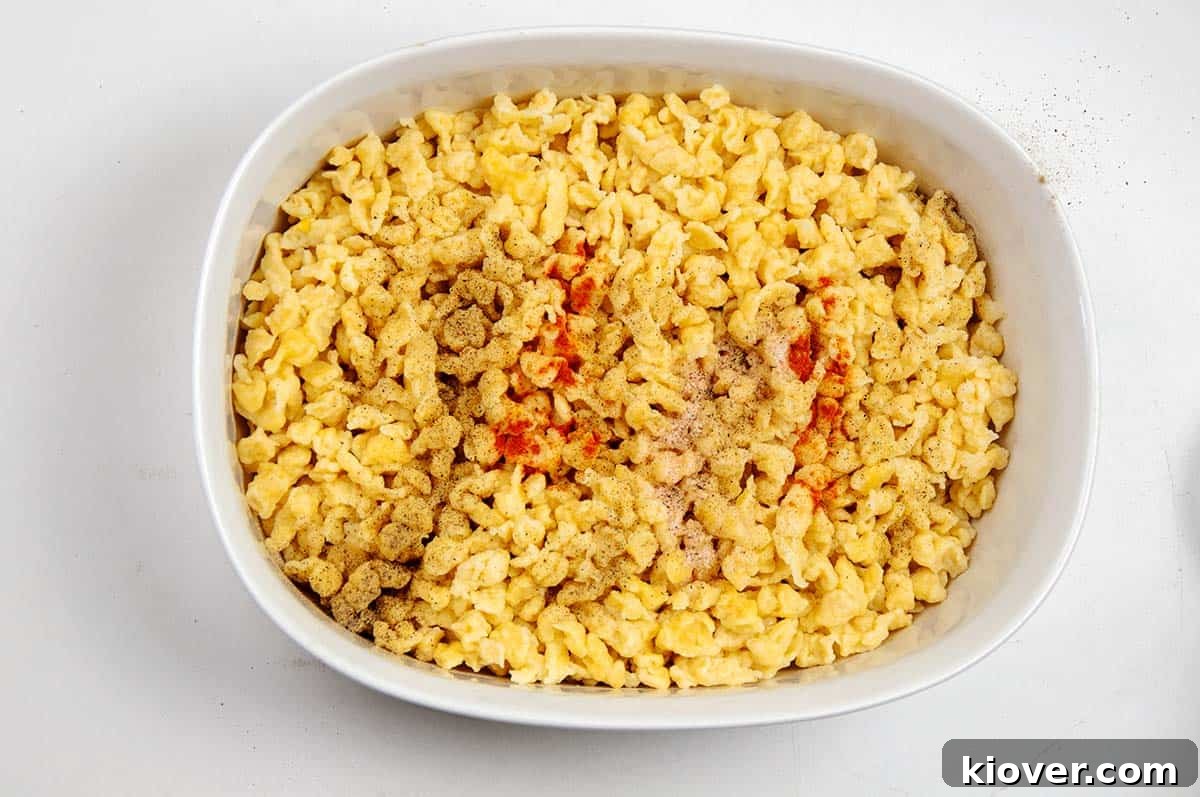 Hearty German Cheese Spaetzle 4 Käsespätzle dumplings with spices on top.