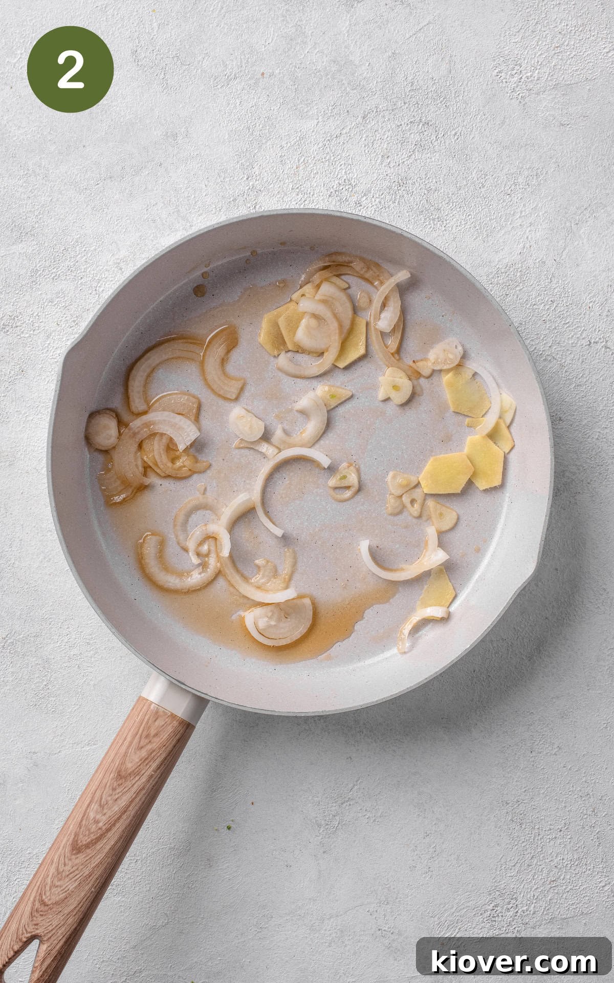 frying the garlic, onion, ginger in sesame oil in a non stick pan, emitting fragrant aromas.