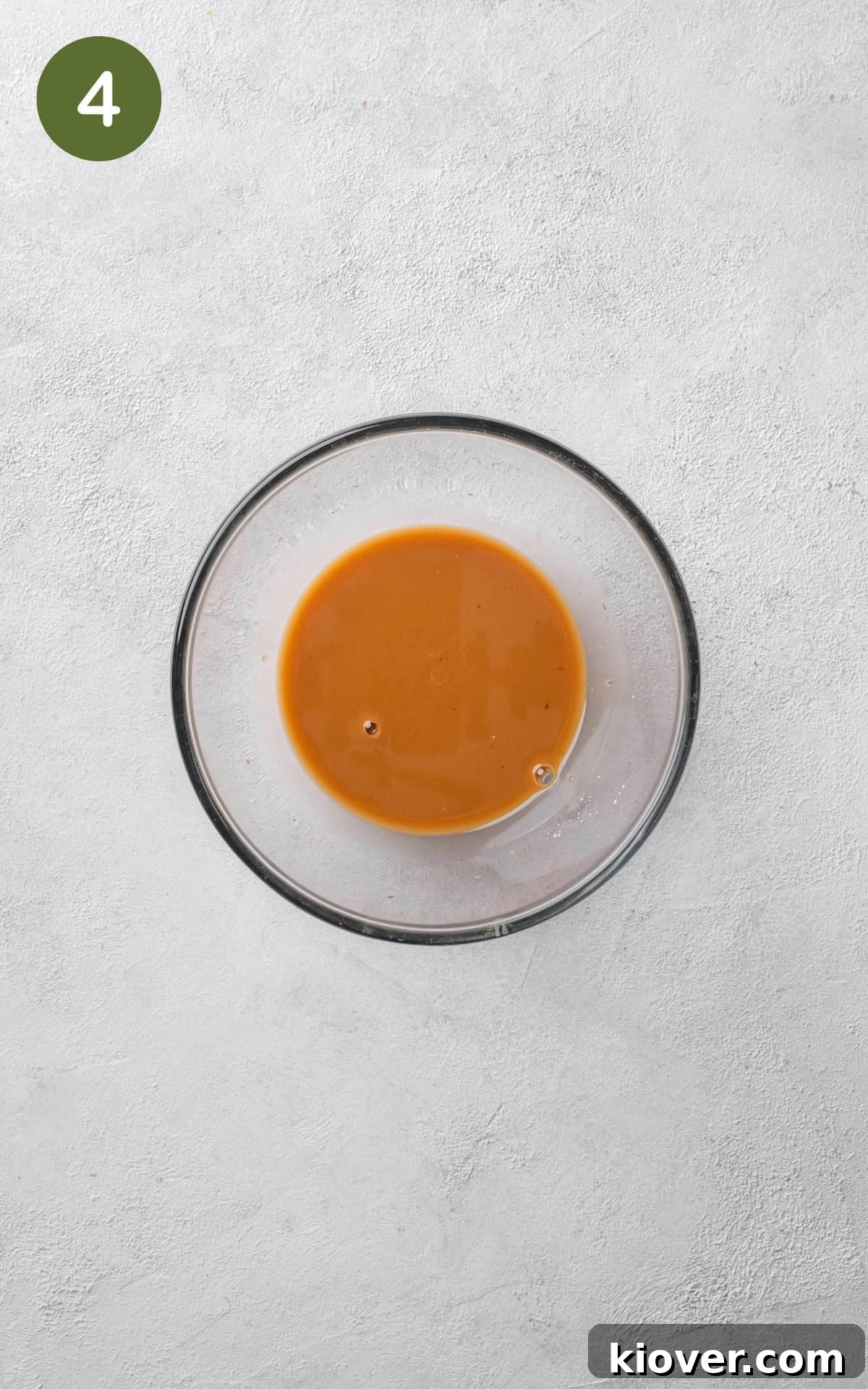 prawn stir fry sauce ingredients mixed together in a glass bowl, ready to be added.