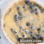 Blueberry tart on a white platter.