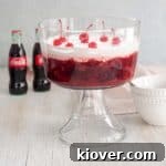 Coca-Cola Salad in a trifle bowl with a bottle of Coke in the background.