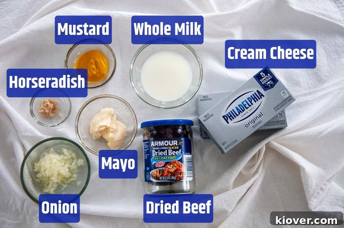 Cheese ball ingredients A visual display of all the ingredients required for the Dried Beef Cheese Ball recipe: Dried Beef, Cream Cheese, Whole Milk, Mustard, Horseradish, mayonnaise, and onion, neatly arranged on a table.
