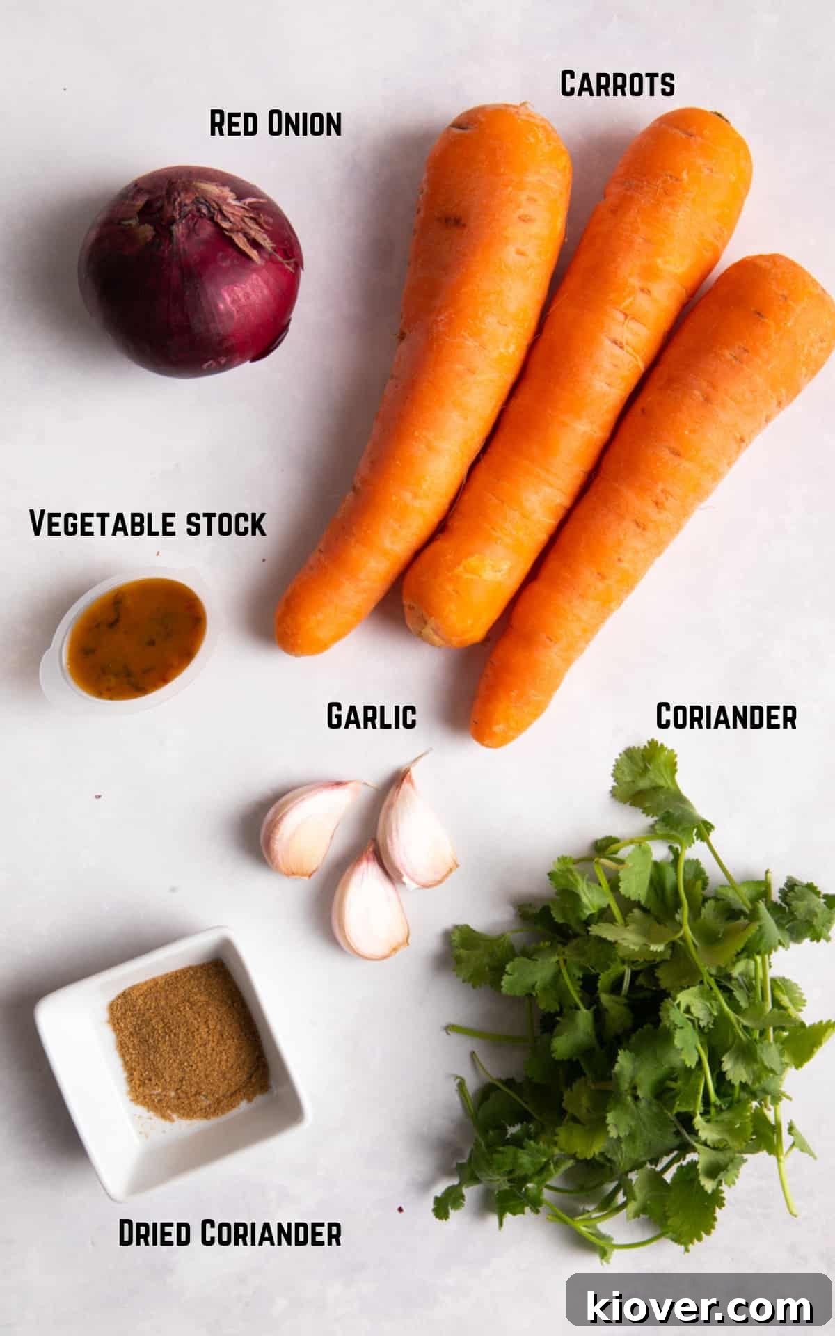 Carrot & Coriander Soup ingredients laid out on a wooden surface.