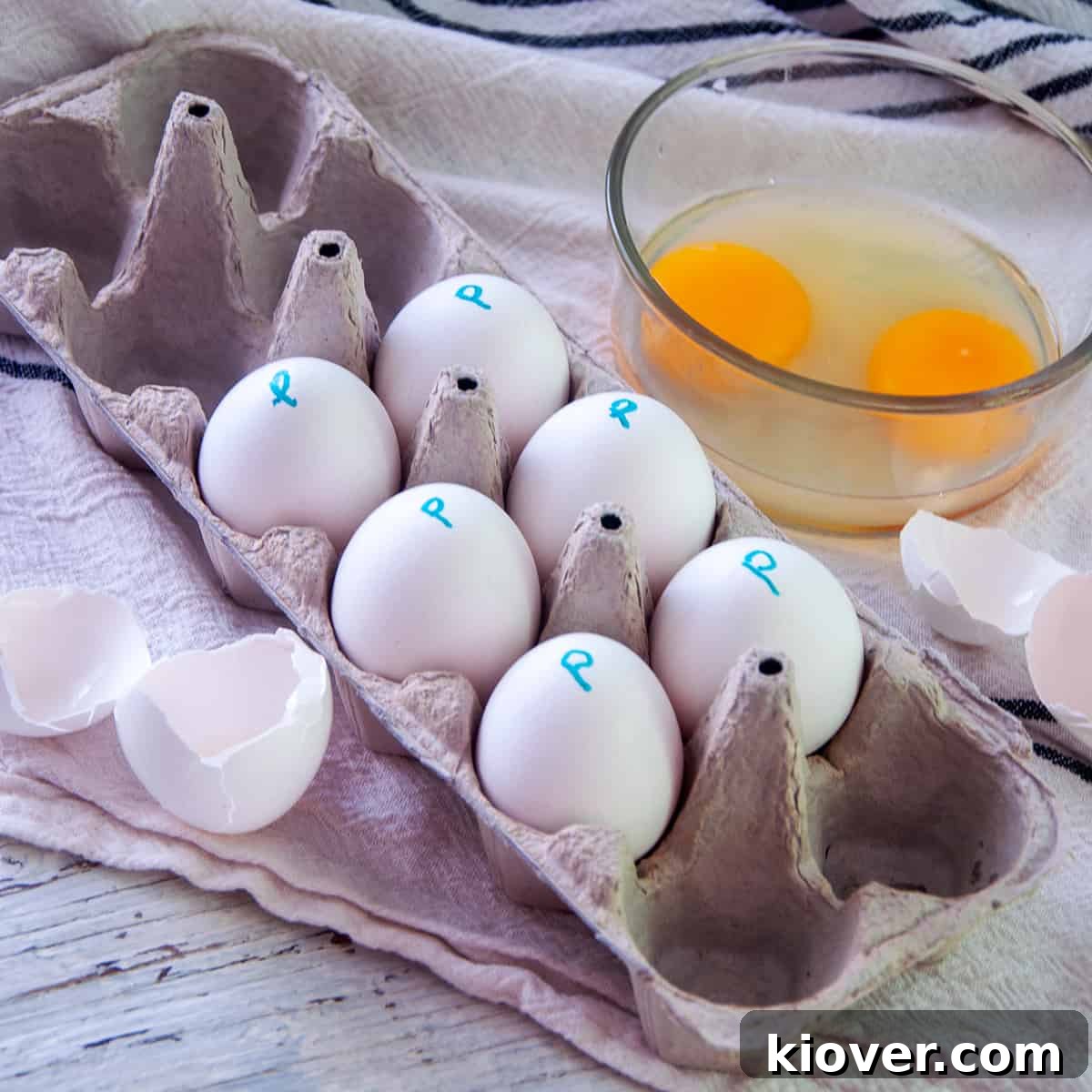 Six pasteurized eggs in an egg carton with the letter 'P' written on them, signifying they have been pasteurized.