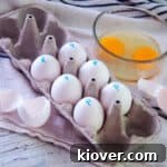 Six pasteurized eggs in an egg carton with the letter 'P' written on them, signifying they have been pasteurized.