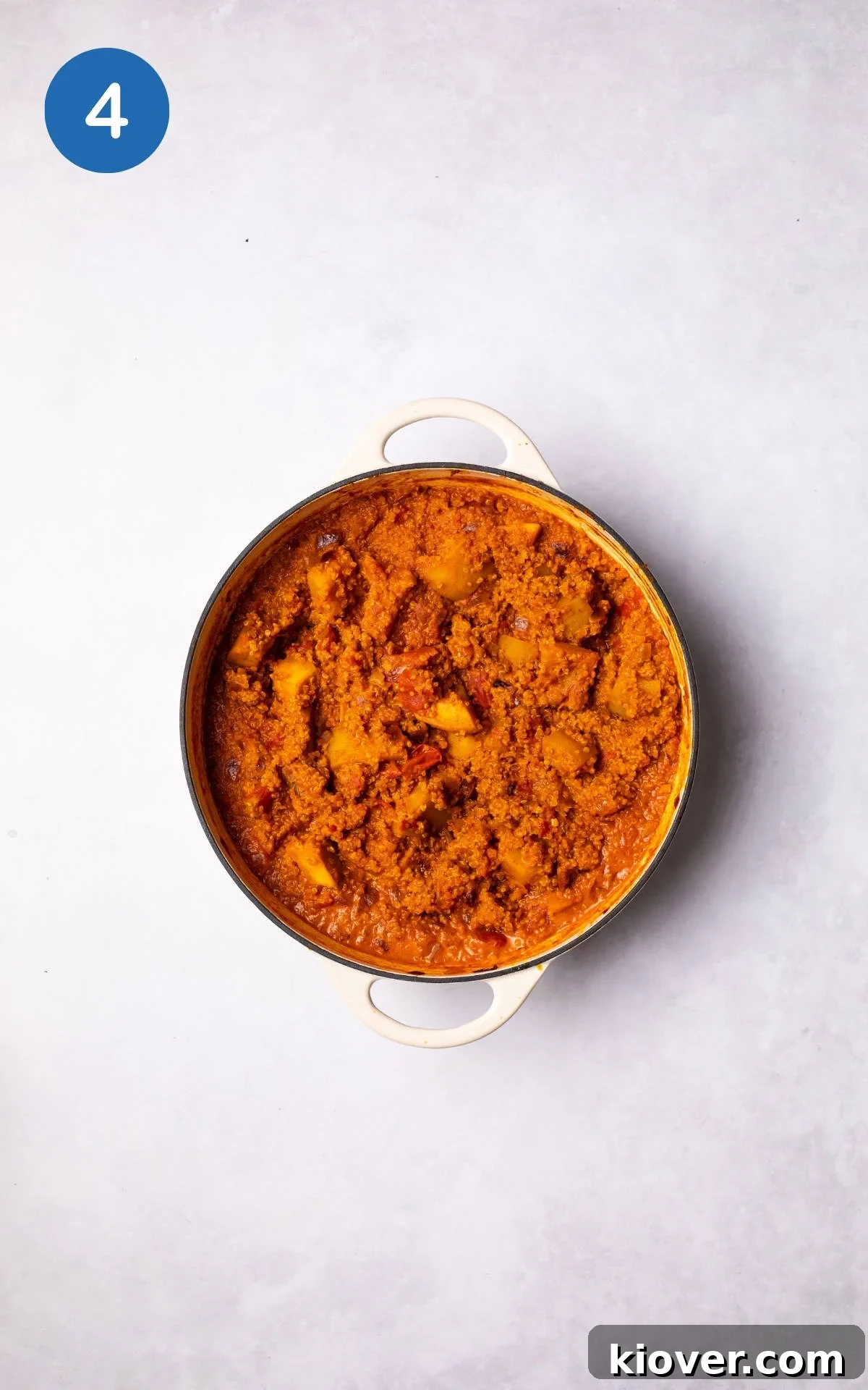 The One-Pot Pumpkin Curry with Quinoa simmering gently in a large pot, rich and vibrant.