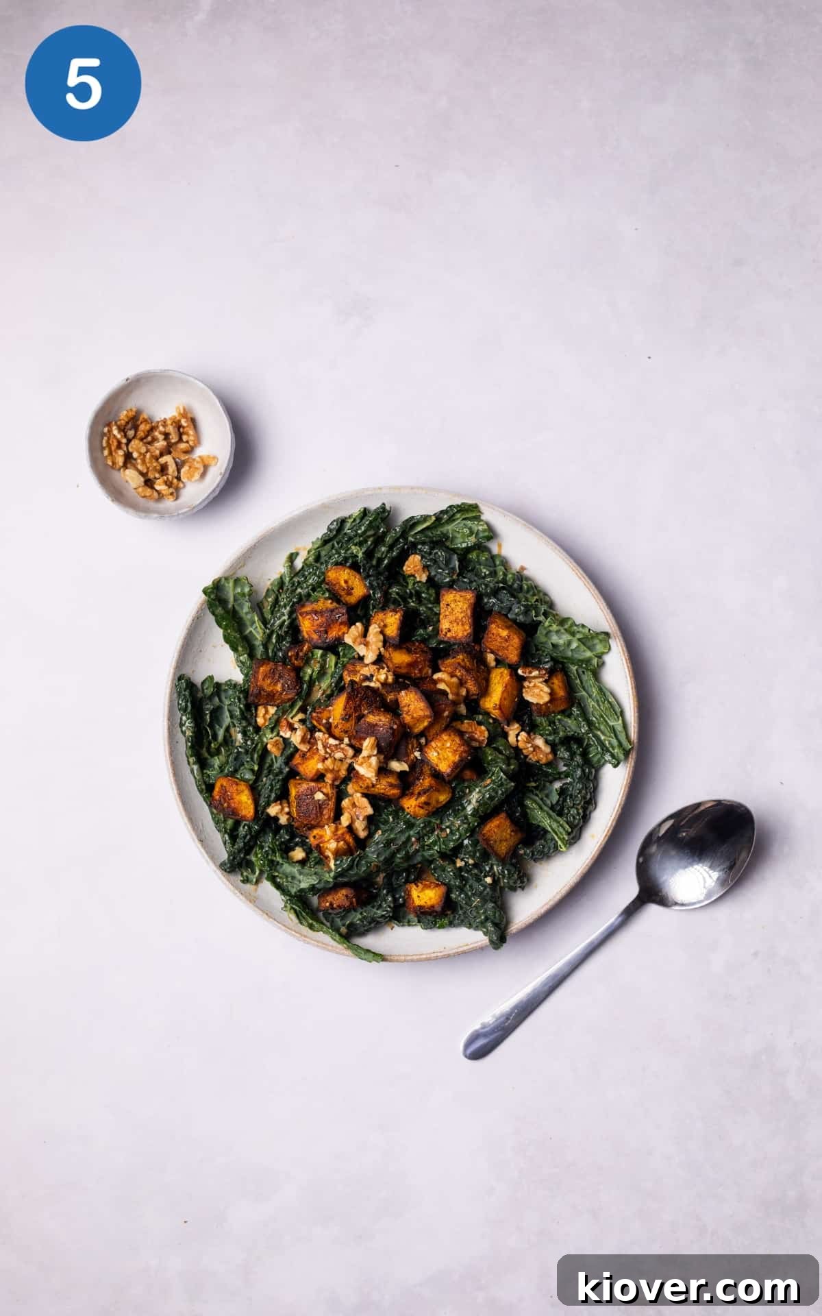 Finished Roasted Pumpkin Salad with Cavolo Nero and walnuts served on a plate.