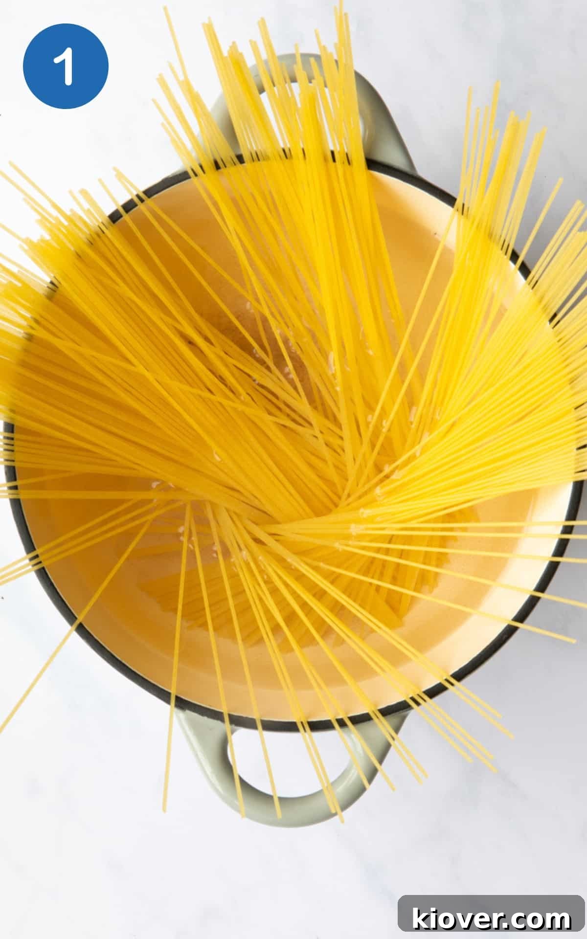 Spaghetti cooking in a pot of salted boiling water.