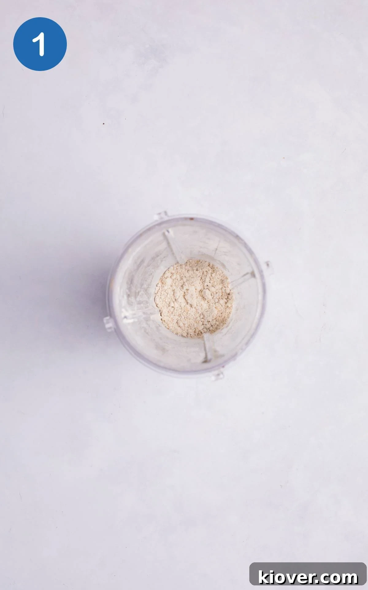 Oats being blended into fine oat flour in a blender, showing the process of making homemade gluten-free flour.