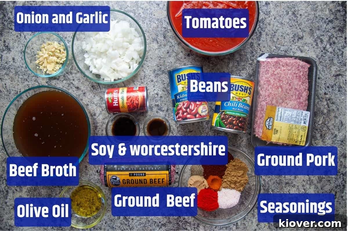 Slow Cooker Chili Ingredients Showcase An array of ingredients for Slow Cooker Chili laid out: ground beef, ground pork, onions, garlic, various canned tomatoes (crushed, diced, paste), beef broth, chili beans, kidney beans, and a selection of spices including chili powder, cumin, paprika, cayenne, salt, pepper, brown sugar, soy sauce, and Worcestershire sauce.