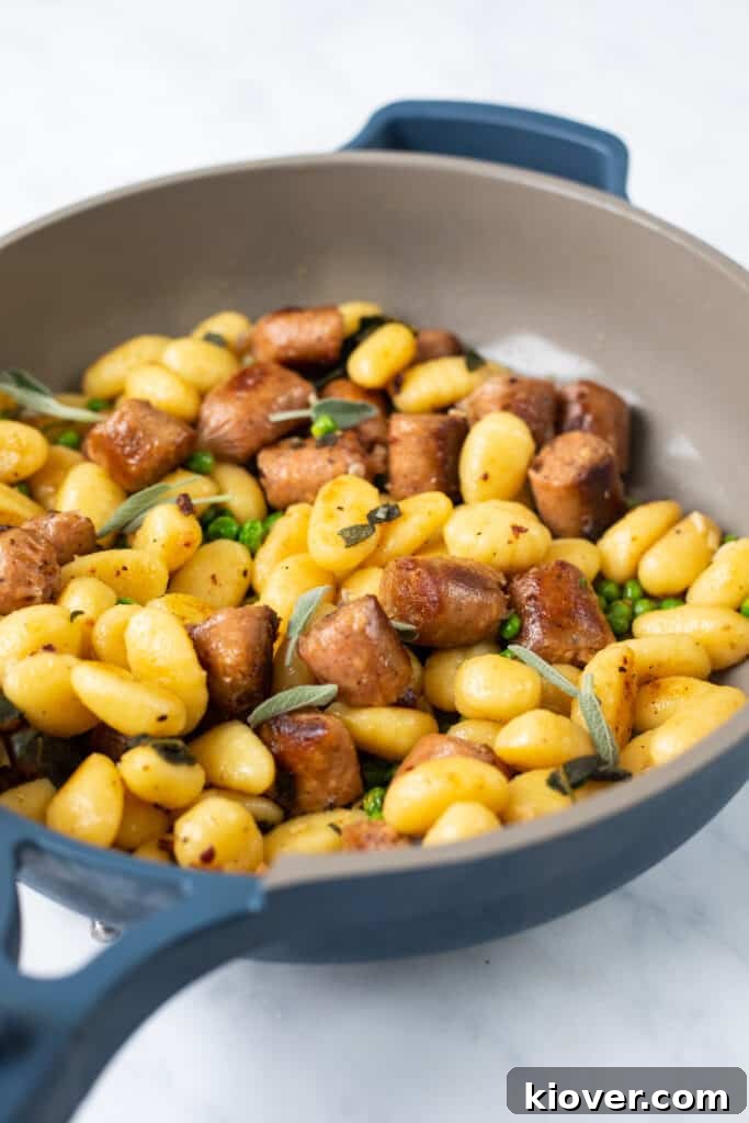 Hearty Sausage and Gnocchi Bake 8 blue non stick pan with cooked gnocchi close up front view.