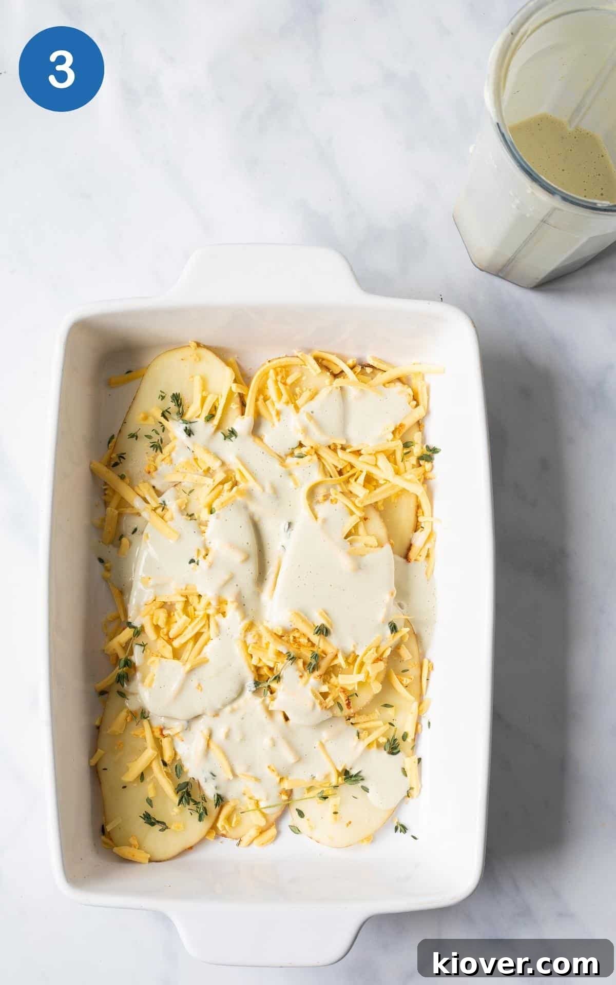 top view of Dijon Mustard, Cheese, milk, Cashews, Thyme in white baking dish.