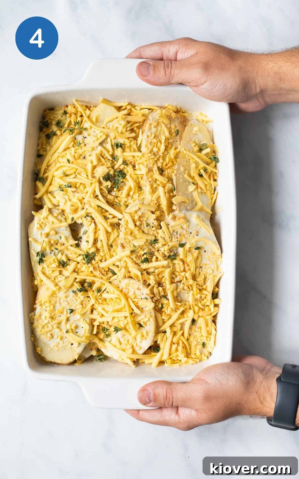 Ready to bake with Dijon Mustard, Cheese, milk, Cashews, Thyme,  in white baking dish.