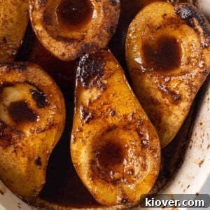 a closeup view of these delicious baked spiced pears coated in a rich sauce.
