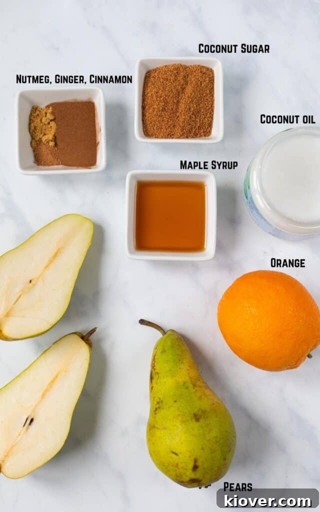 ingredients on marble backdrop. Nutmeg, ginger, cinnamon, coconut sugar, maple syrup, coconut oil. orange, pears.