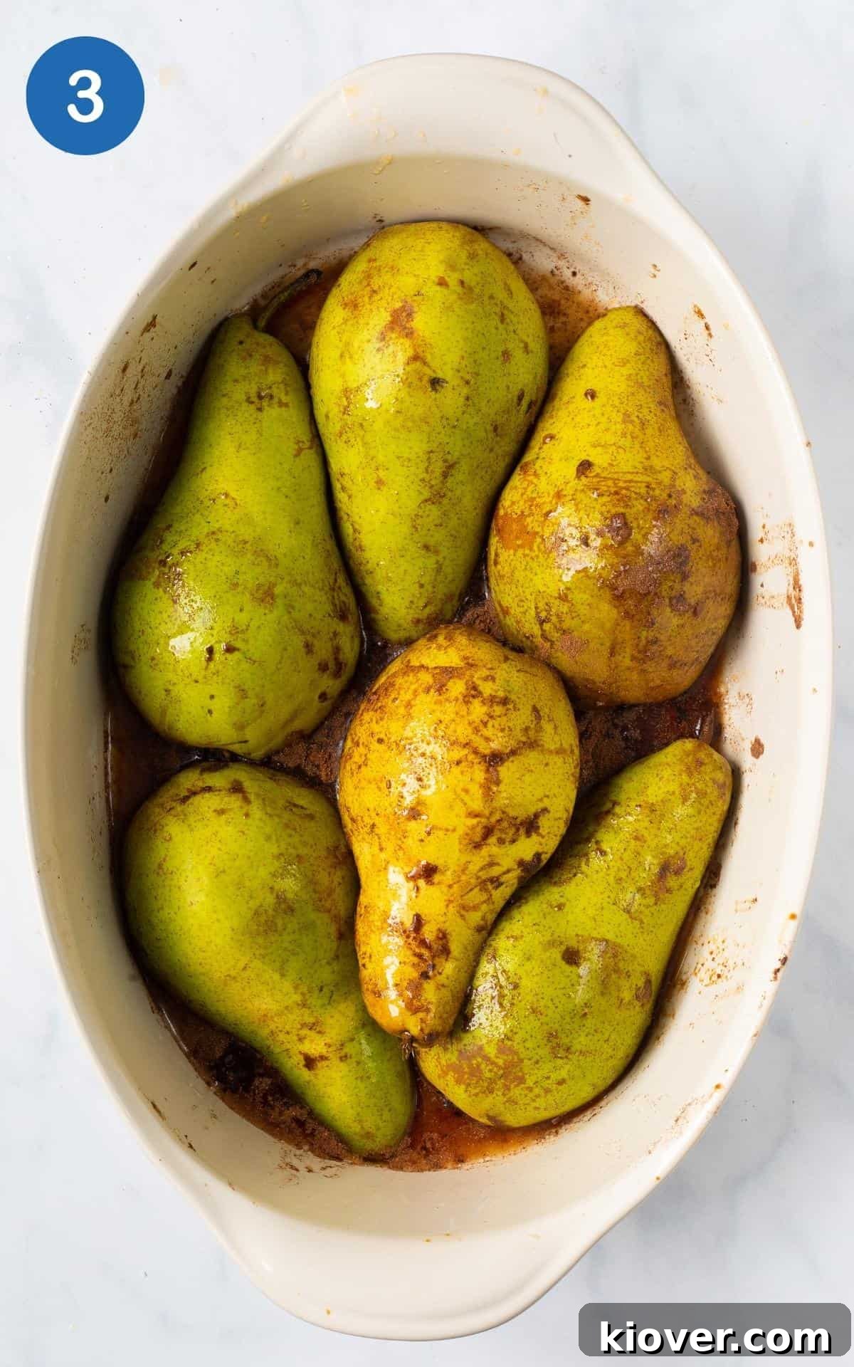 pears upside down in white baking dish ready for baking.