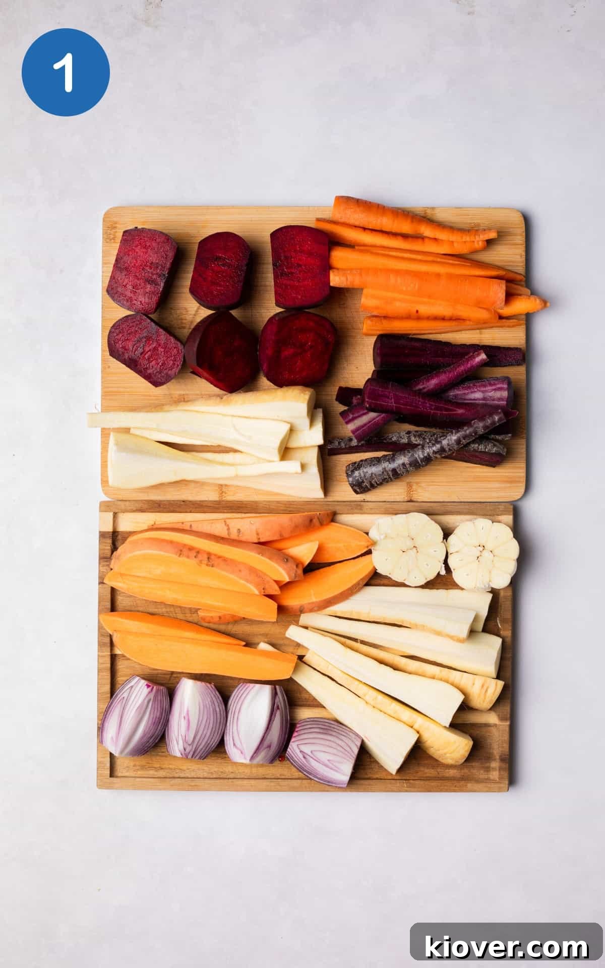 Assorted root vegetables on a wooden cutting board, prepped for roasting.