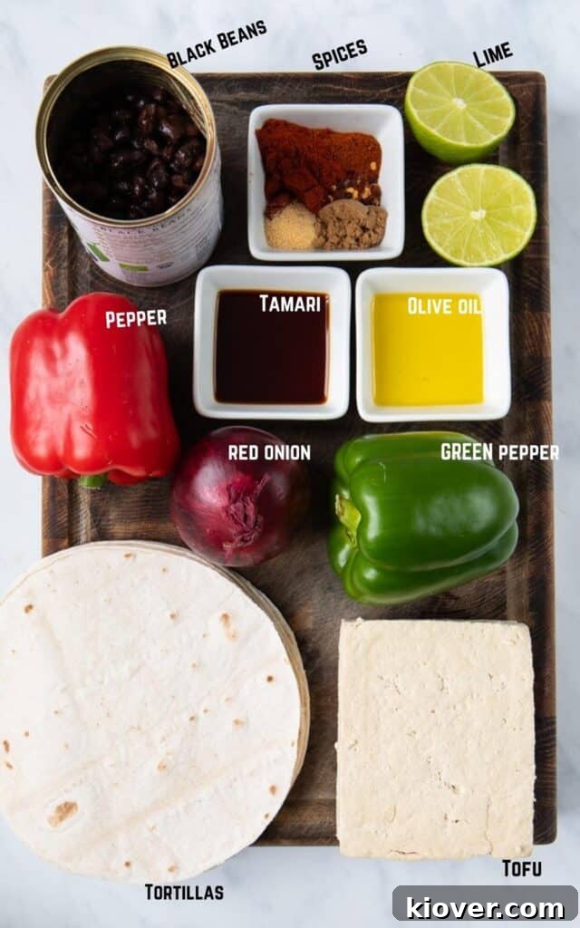 Key ingredients for One Pan Tofu Fajitas: Black Beans, a variety of Spices, Lime, Bell Peppers, Tamari, Olive Oil, Red Onion, Tofu, and Tortillas.
