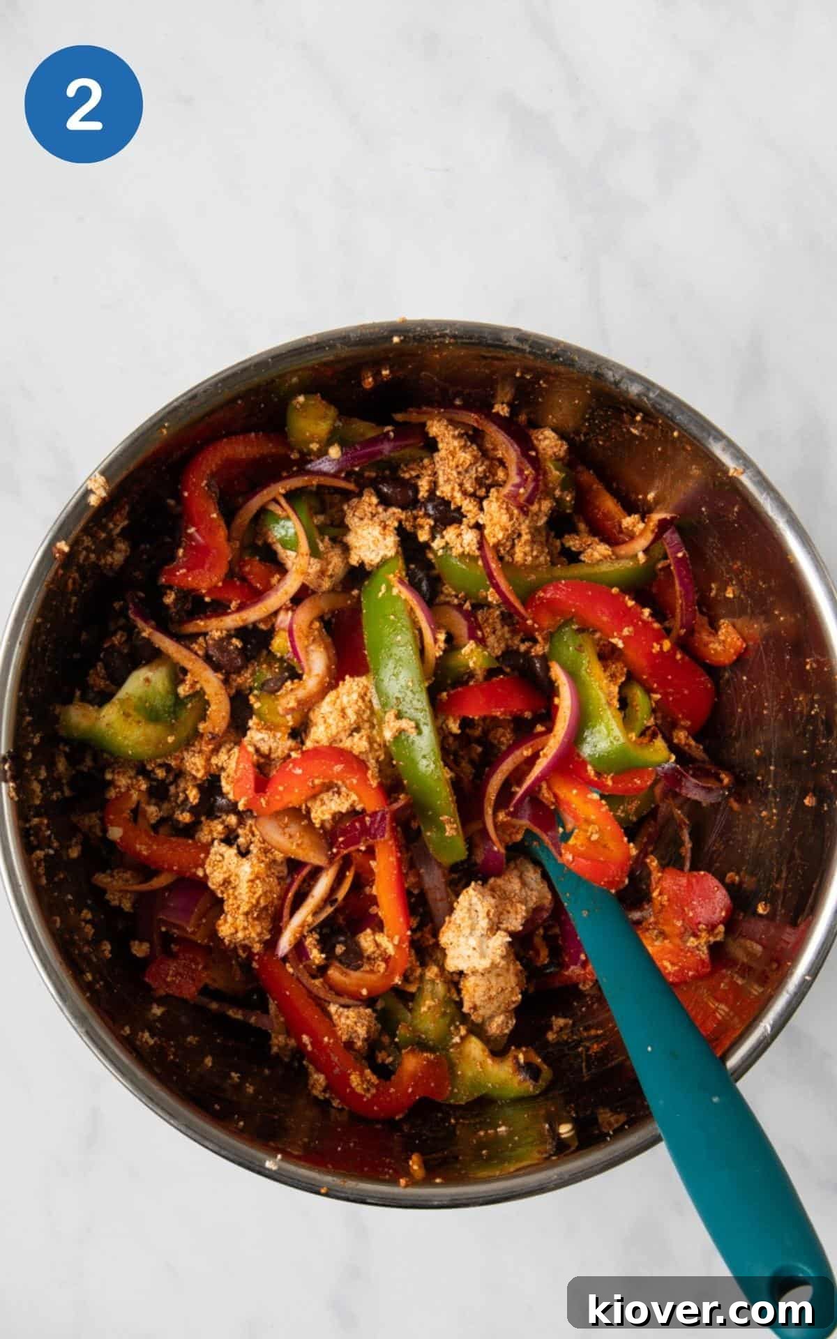 Spices, Black Beans, Red Pepper, Tamari, Olive oil, red onion, and green pepper combined together in a large mixing bowl with crumbled tofu.