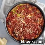 A perfectly baked Chicago Deep Dish Meat Lover Pizza, golden brown and bursting with savory ingredients.