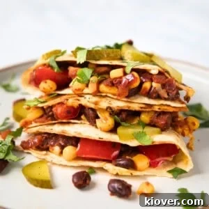 Filled black bean quesadillas on a white plate, ready to serve.