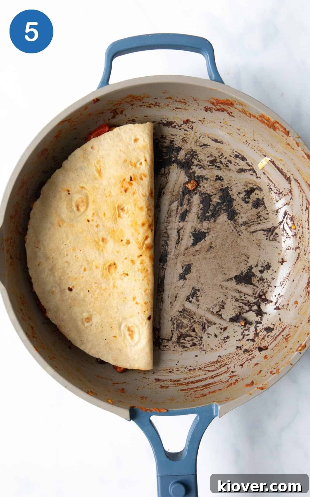 Zesty Black Bean Melts 8 A black bean quesadilla folded in half and pressed gently in the frying pan, cooking until the tortilla is golden brown and crispy, and the cheese is melted and gooey.