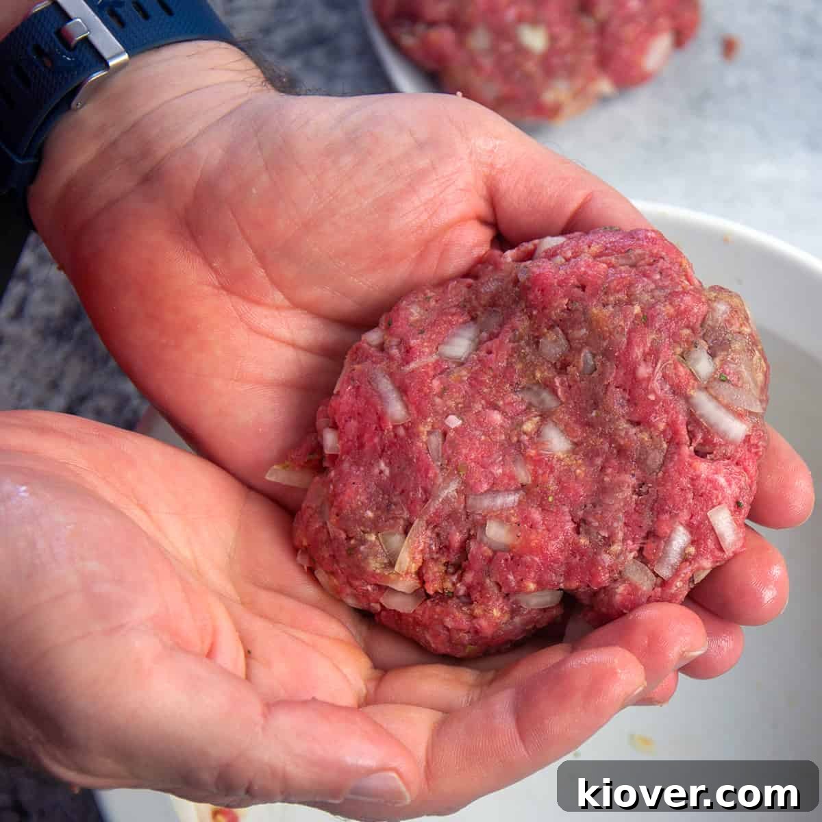 Shaping Salisbury Patties One beef patty being shaped by hand.