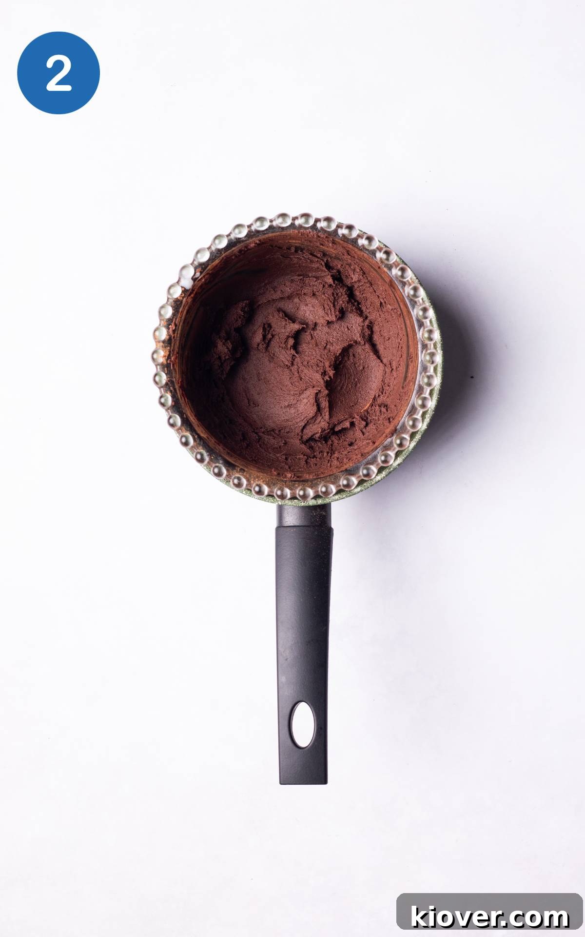 Decadent Vegan Chocolate Truffles 5 Cacao powder being slowly whisked into the warm coconut oil and maple syrup mixture.