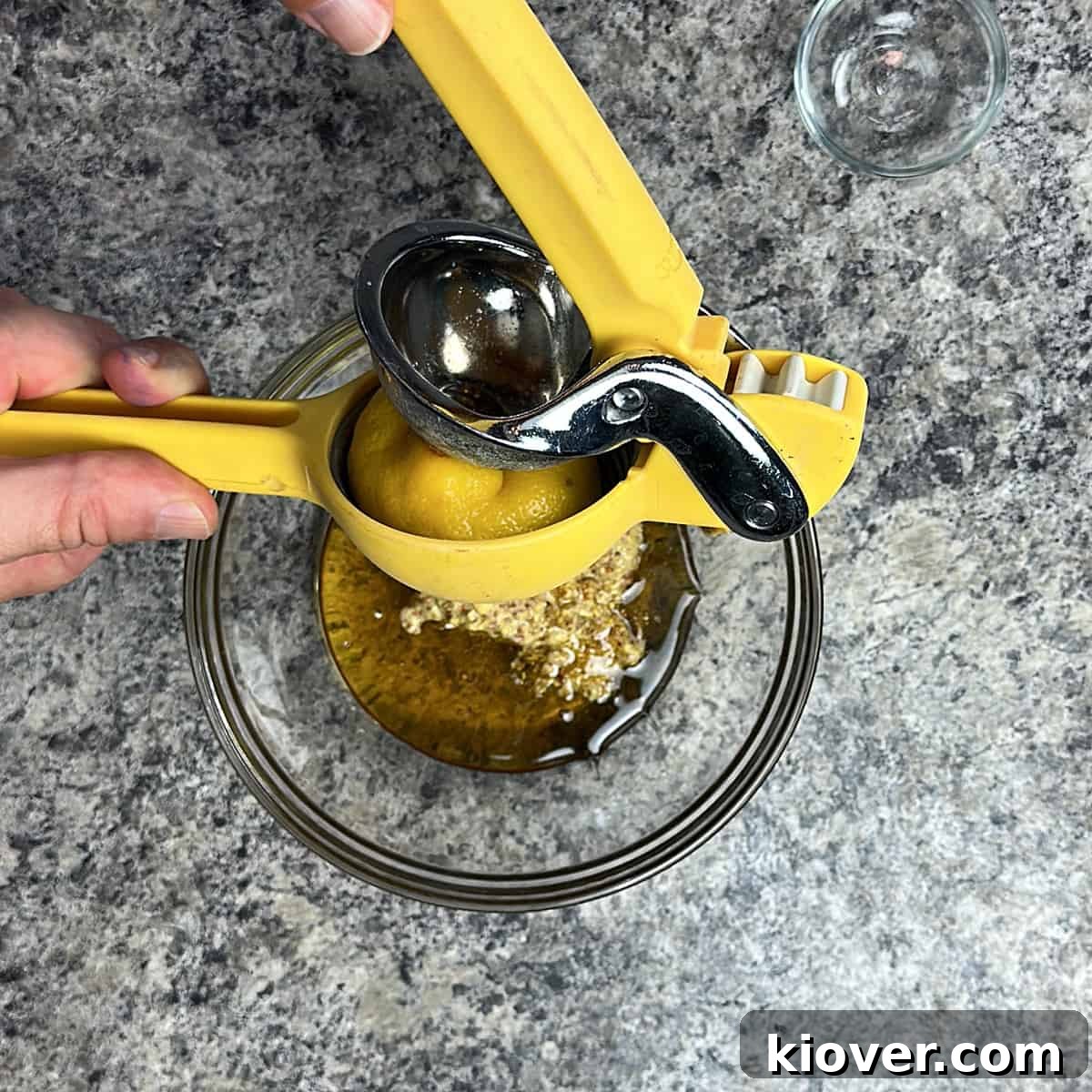 Squeezing Lemon Squeezing lemon into a bowl with honey and mustard.