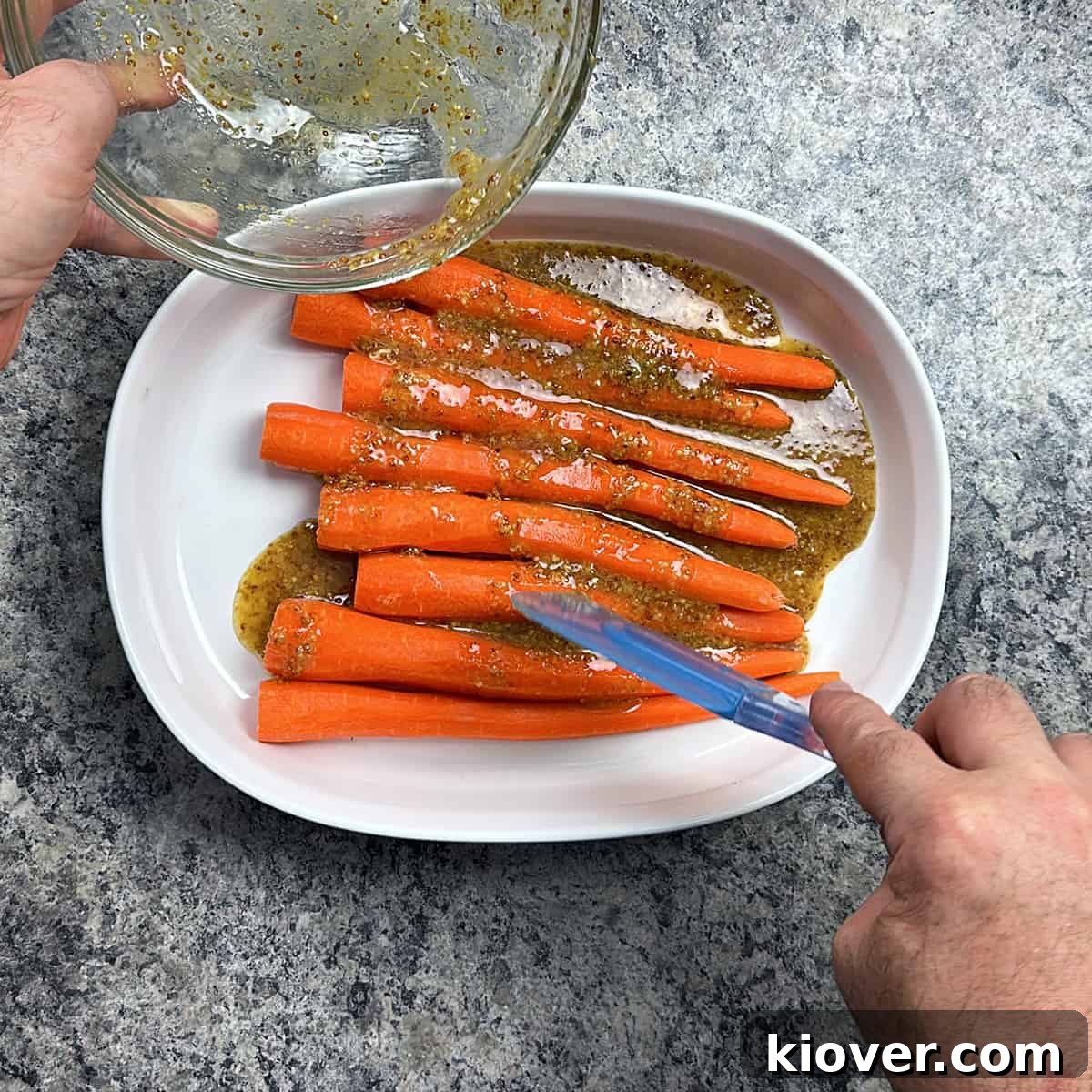 Glazing Carrots Carrots in a dish and pouring the honey mustard over the raw caw carrots.
