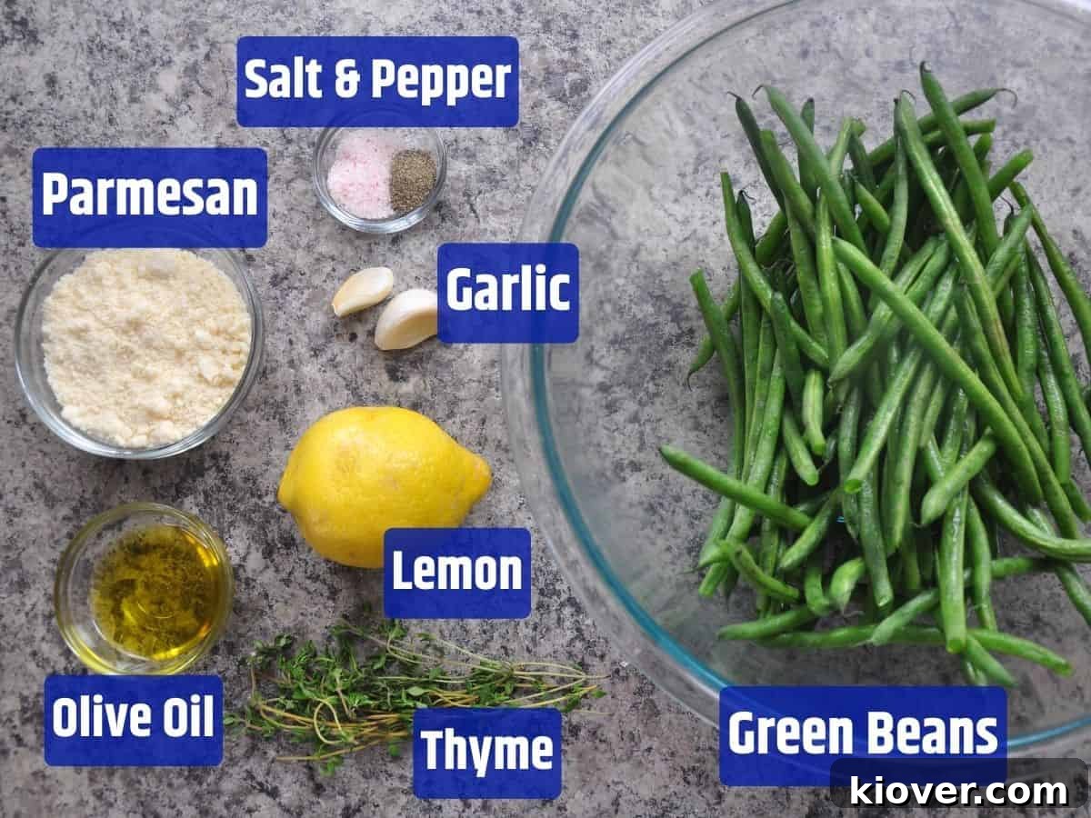 Fresh ingredients laid out for grilled green beans in a tinfoil packet, including green beans, olive oil, thyme, lemon, parmesan cheese, and garlic.