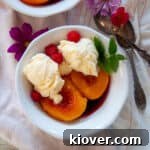 A white bowl containing a serving of peach melba.