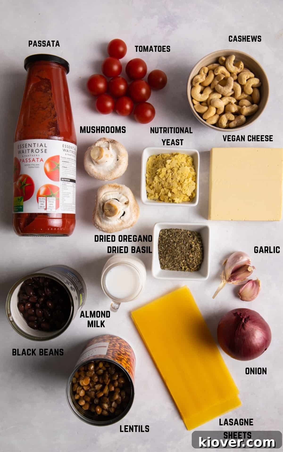 Plant-Based Lasagne Perfection 3 An assortment of fresh, colorful ingredients for making homemade vegan lasagne, neatly arranged on a white surface.