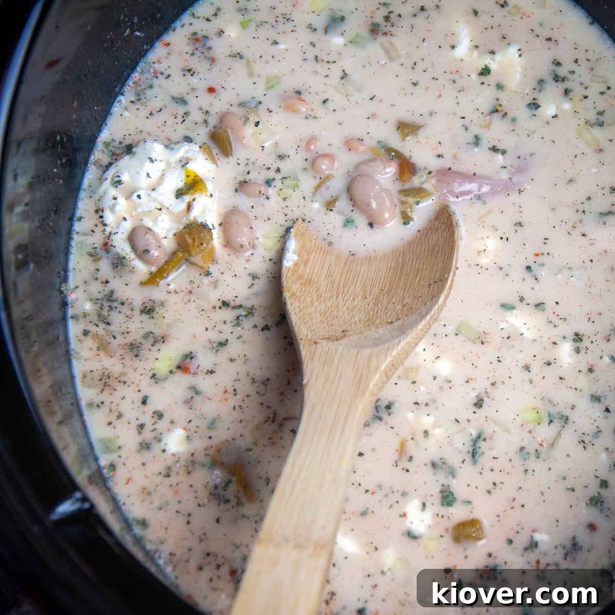 Uncooked Chili White chicken chili being mixed in a crockpot.