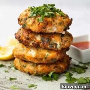 Sweet Chilli Salmon Fishcakes stacked on top of each other, topped with coriander