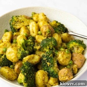 Image shows a close up of Sausage Pesto Gnocchi served in a bowl with a white background.