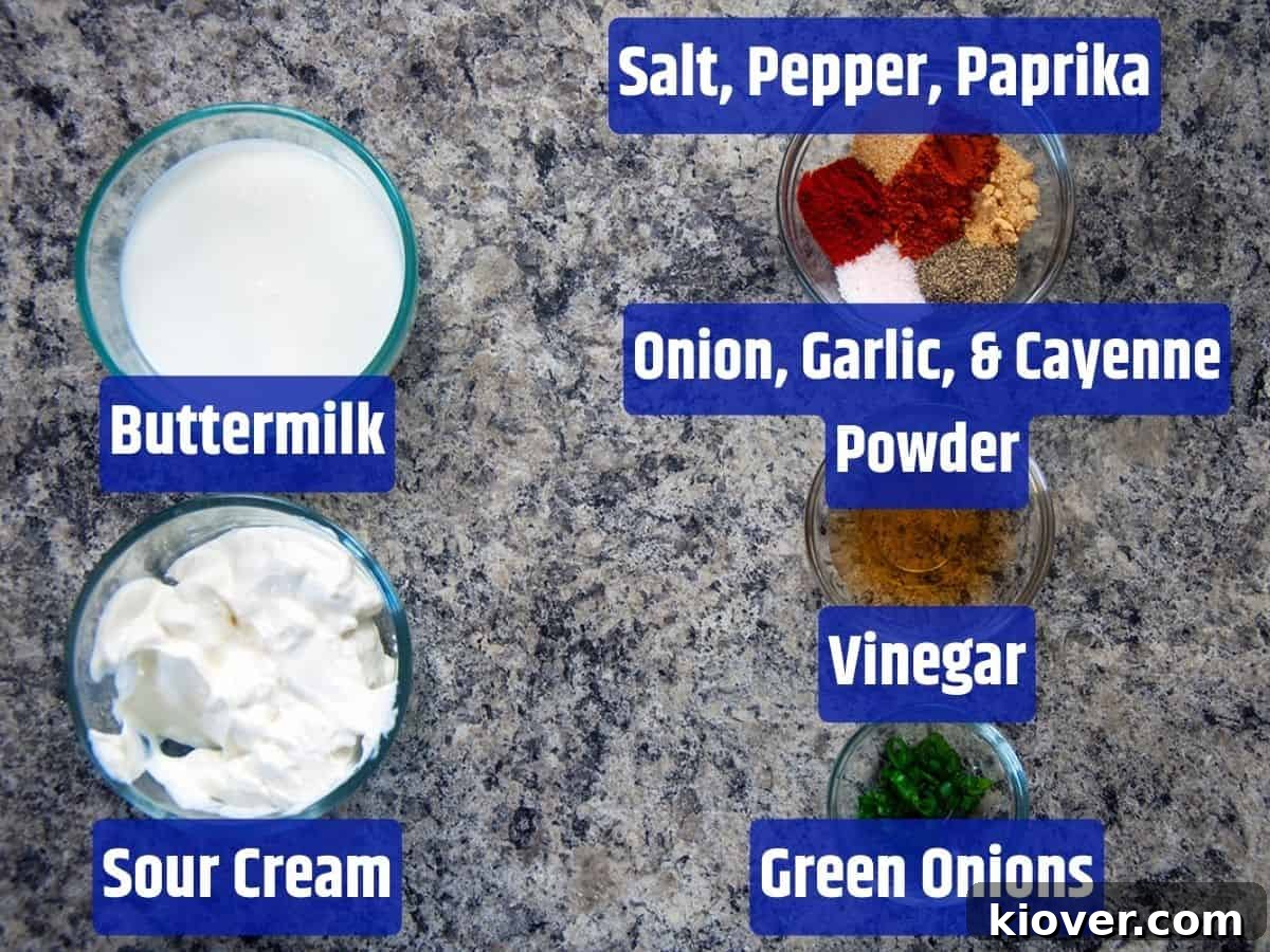 A flat lay photograph showcasing all the ingredients required for the homemade sour cream dip, neatly arranged on a rustic surface.