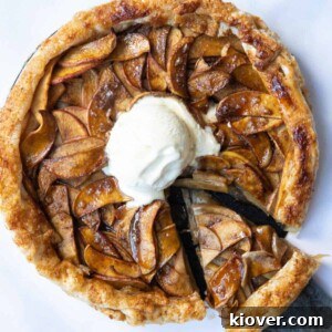 Puff Pastry Apple Tart on a white marble background with a scoop of ice cream in the centre