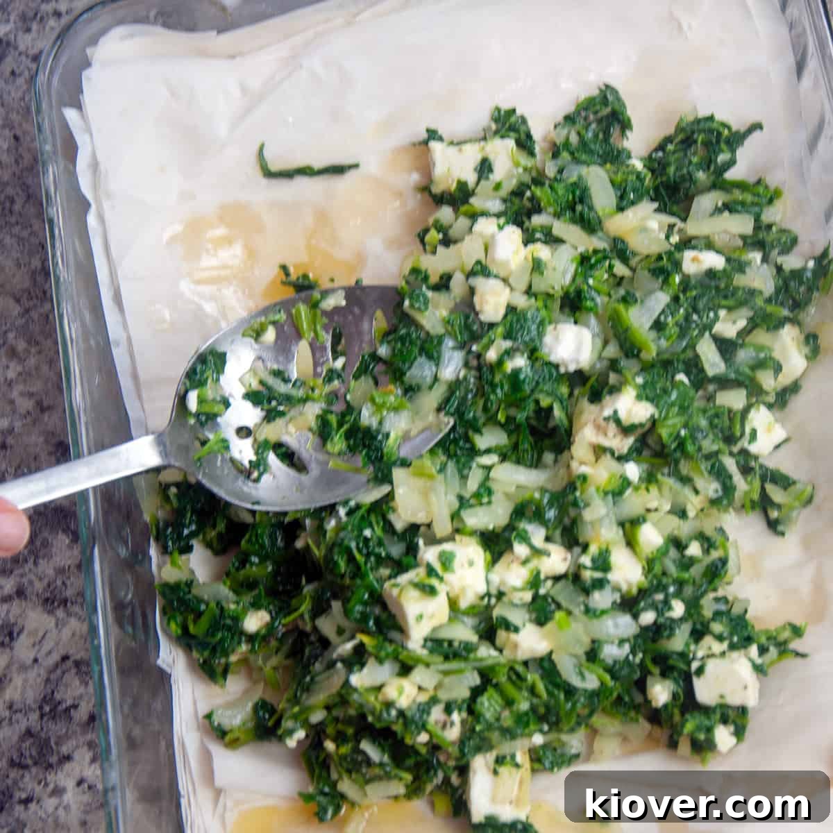 Spinach mixture laying on phyllo dough.