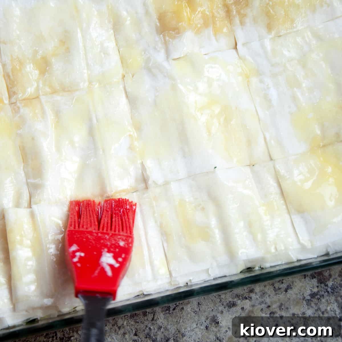 A silicon brush slathering the last of the butter on top.