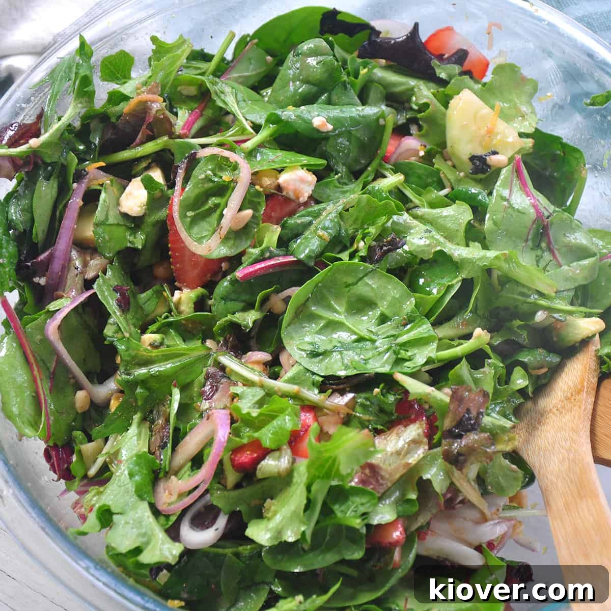 Vibrant Strawberry Salad with Zesty Vinaigrette 4 Mixed salad and ingredients in a bowl.