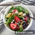 A bowl of strawberry salad with easy vinaigrette salad.