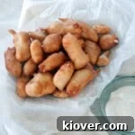 Pile of cheese curds with a side of ranch dressing.