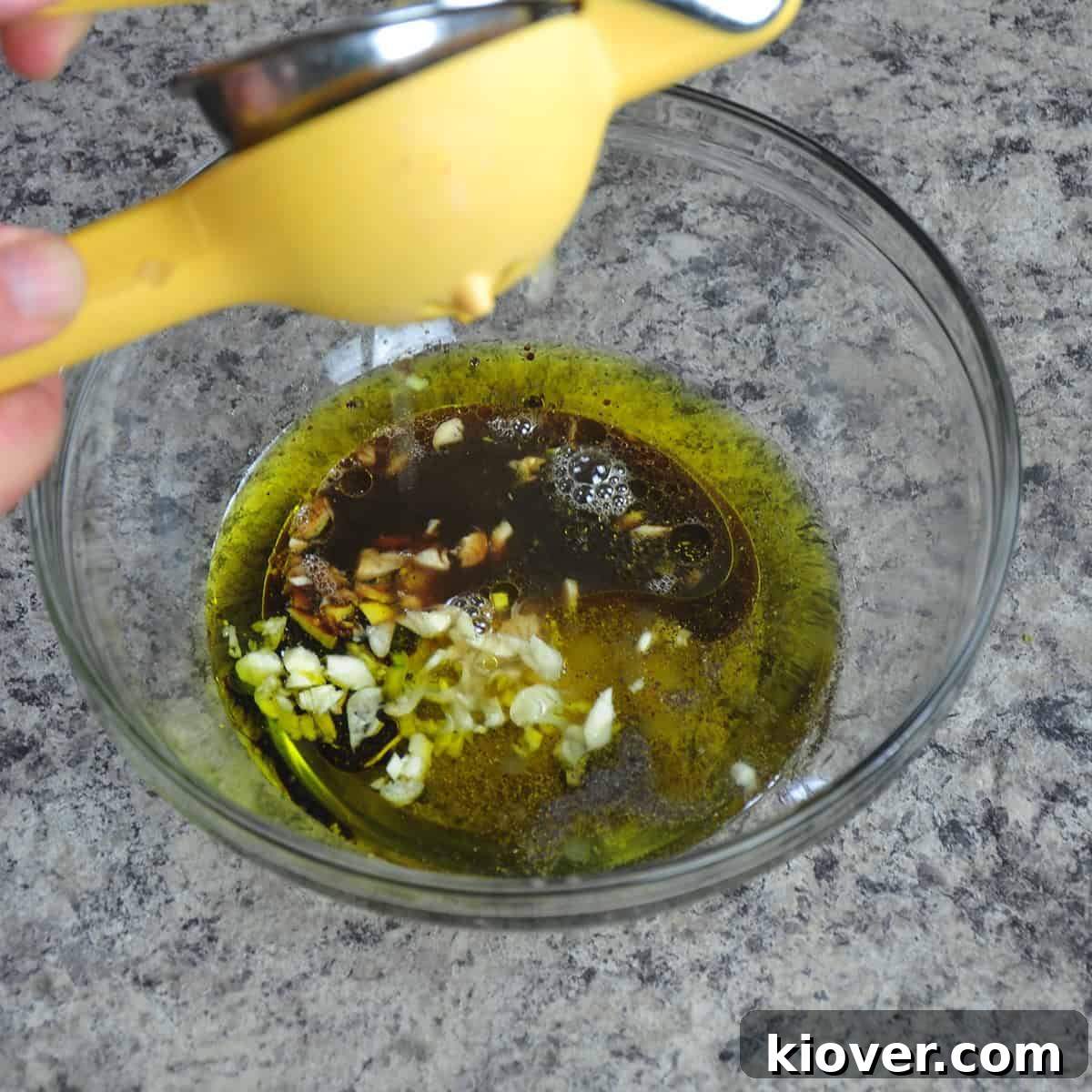 Orzo Salad Dressing Preparation Squeezing lemon into the orzo salad dressing mixture.