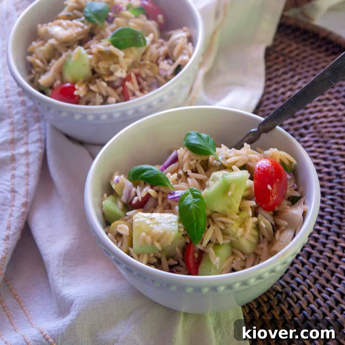 Mediterranean Orzo Salad Ready to Serve Two white bowls filled with fresh Mediterranean orzo salad.