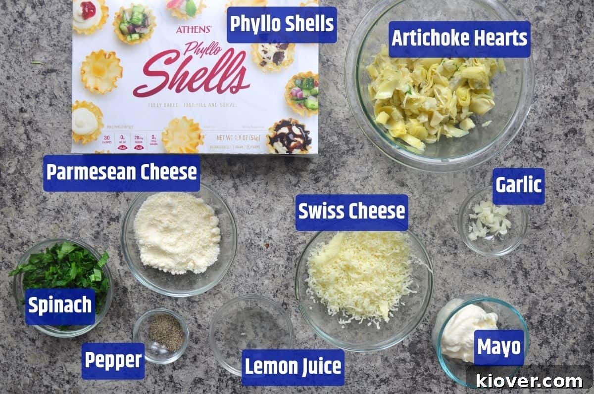 Phyllo Cup Ingredients All the fresh ingredients laid out for making Spinach and Artichoke Phyllo Cups, including artichoke hearts, spinach, cheeses, and spices.